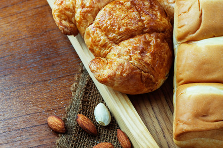 Bread of croissants on tray with wooden background.の写真素材