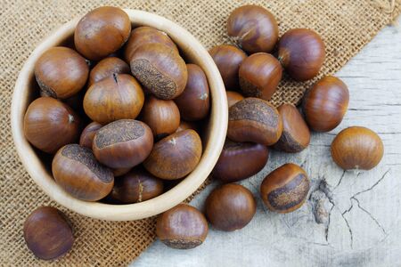 Chestnut in bowl and wooden floor.の写真素材