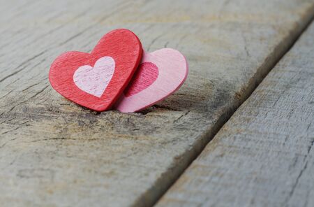 Two heart shape on wooden floor.の写真素材