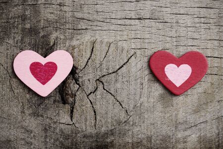 red and pink hearts on wooden floor.の写真素材
