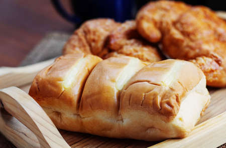 Bread on tray with coffee cup at table.の写真素材