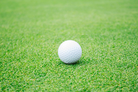 Golf ball on the green lawn.の写真素材