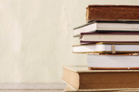 Old books stacked on wooden floor.の写真素材