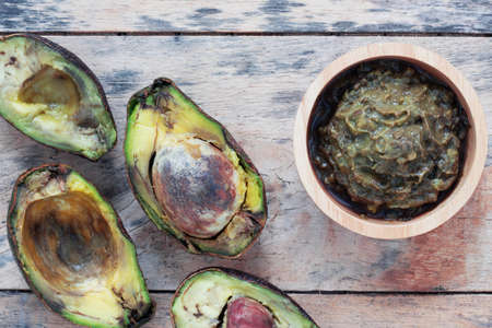 avocado is ripe and rotten on the old wooden floor.の写真素材
