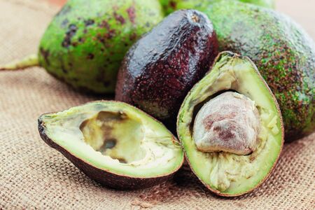 Ripe and raw of avocado on sackcloth.の写真素材