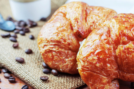 Croissants and coffee on a sack.の写真素材