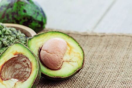 cut of avocado and green on sackcloth.の写真素材