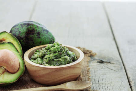 Grated avocado in bowl and green on sackcloth.の写真素材