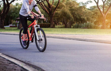 Women are cycling on the streets in parks.の写真素材