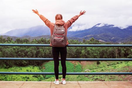 Young woman with joy of nature on the mountain.の写真素材