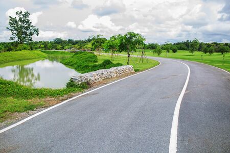 Road in the park with green trees.の写真素材