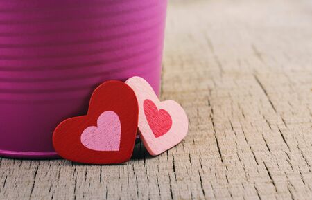 Two hearts and vases on wooden floor.の写真素材