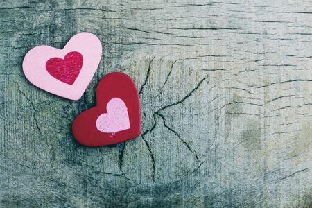 Two hearts on the old wooden floor.の写真素材