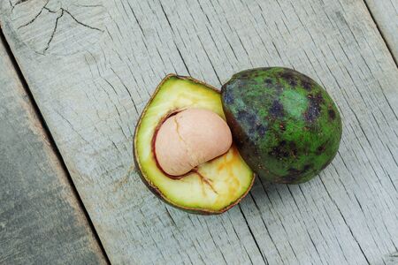 Avocado cut of half and stacked on the old wooden floor.