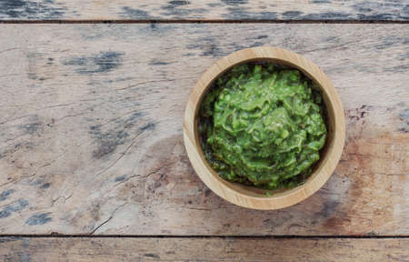 Fresh avocado in a bowl on the old wooden floor.の写真素材