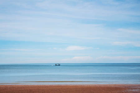 Beach and boat on the blue sea at sky.の写真素材