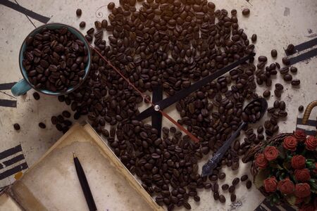 Coffee beans and old books on ancient watches.の写真素材