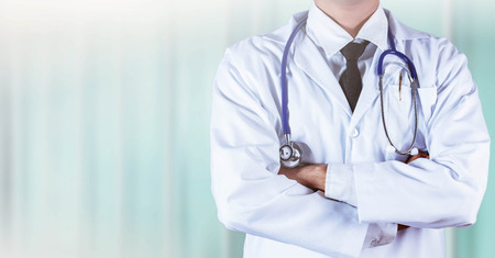 doctor is pondering with the fever instrument on neck.の写真素材