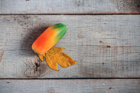 Papaya is ripe on old and dirty wooden floor.の写真素材