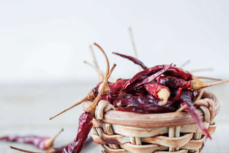 Chillies dried on bowl with a white background.の写真素材