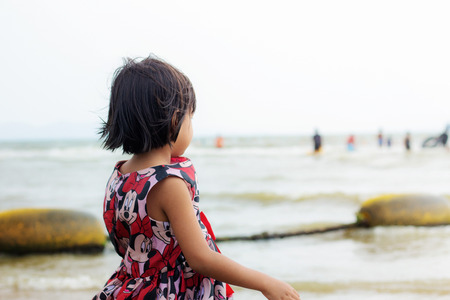 Girl is standing on the beach.の写真素材