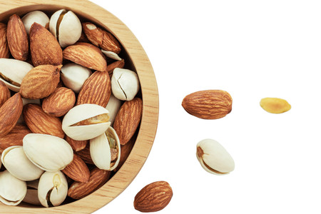 Almond in wooden bowl on a white background.の写真素材