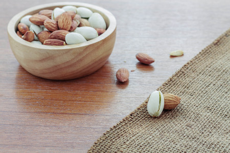 Almond on sackcloth and wooden floor.の写真素材
