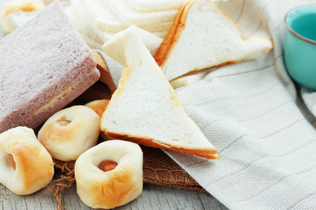 Many kinds of bread on wooden boards.の写真素材