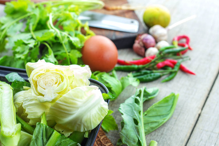 Cabbage and spices on wooden floor.の写真素材