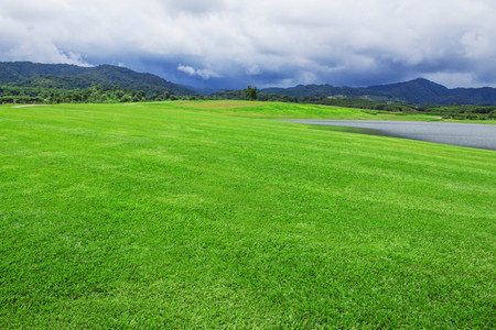Lawns and ponds in the park on mountains.の写真素材