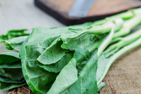 Green leaf kale on wooden floor.の写真素材