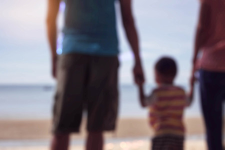 Parents and children at the sea with blurred images.の写真素材