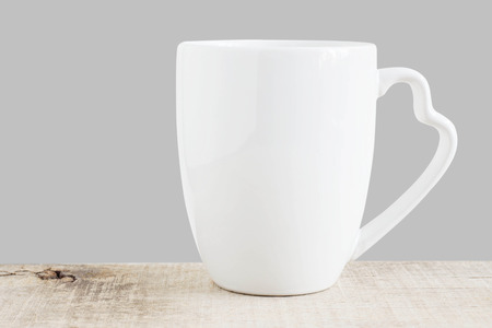 White coffee cup on old wooden floor.の写真素材