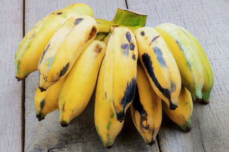 Banana ripe and rotten on wood with background.の写真素材