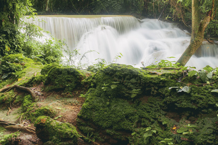 Waterfall and stone with natural in the rainy season at sunlight.