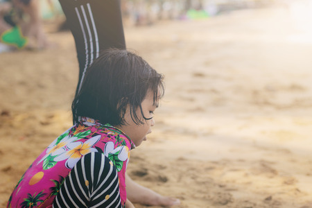Children of asia are playing on beach in summer.