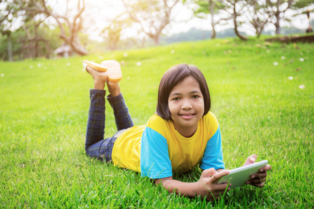 Asian girls are happy on lawn in the park.の写真素材