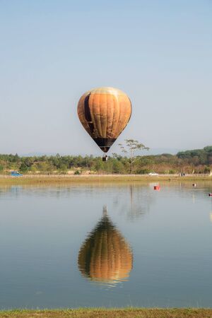 Balloon on the sky in field at lake.の写真素材