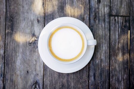 Coffe cup on wooden table with top view.の写真素材