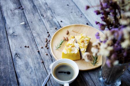 Cake on tray and coffee cup with wooden background.の写真素材