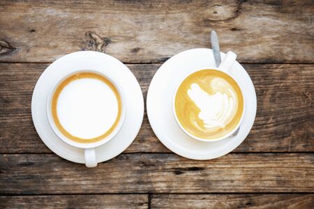 Coffee cup of twin on wood with texture background.の写真素材