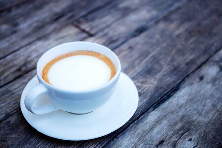 Coffee cup on wooden table with background.の写真素材