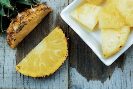 Pineapple of slices on wooden with texture background.の写真素材