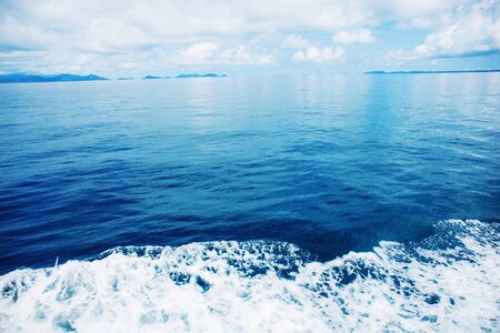 Waves on blue sea with the sunlight at sky.の写真素材