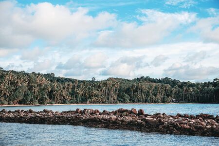 Coastline and stone at the sea with blue sky.