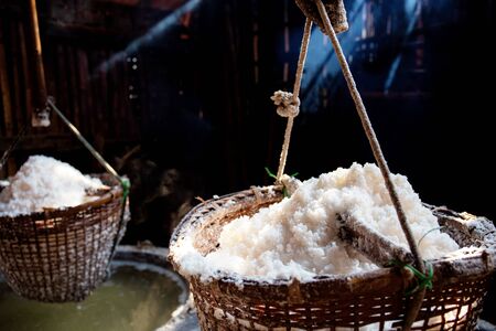 Basket of salt hanging at home with the sunlight in Thailand.の写真素材