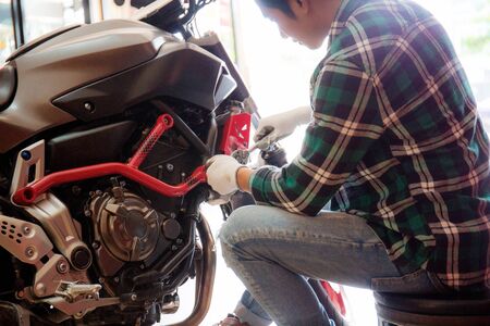 Motorcycle mechanic in the garage with the sunlight.の写真素材