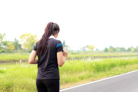 Girl running on street in the park.の写真素材