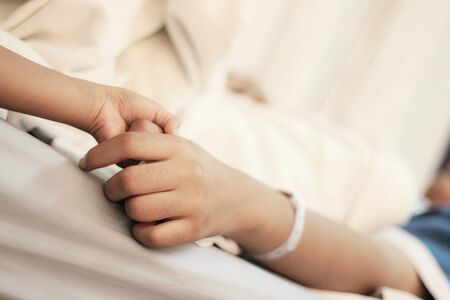 Hands of patients and relatives at the hospital.の写真素材
