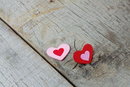 Two hearts on wooden floor with background.の写真素材